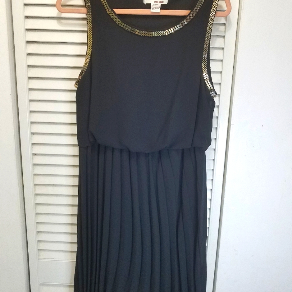 Black pleated dress, longer in the back.  Metal trim